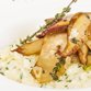 photo of delicious risotto dish with herbs and mushrooms on whit